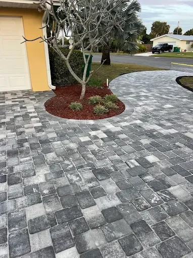 Melbourne and Palm Bay outdoor living contractor providing paver patios, pool decks, driveways, walkways, outdoor kitchens, fire pits, retaining walls, drainage solutions, concrete installation, decorative rock, and artificial turf.