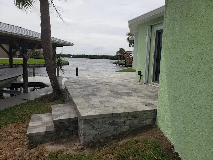 Hardscape contractor serving Brevard County with custom paver driveways, pool decks, patios, walkways, retaining walls, seating walls, outdoor kitchens, fire pits, drainage systems, concrete work, and landscape enhancements.