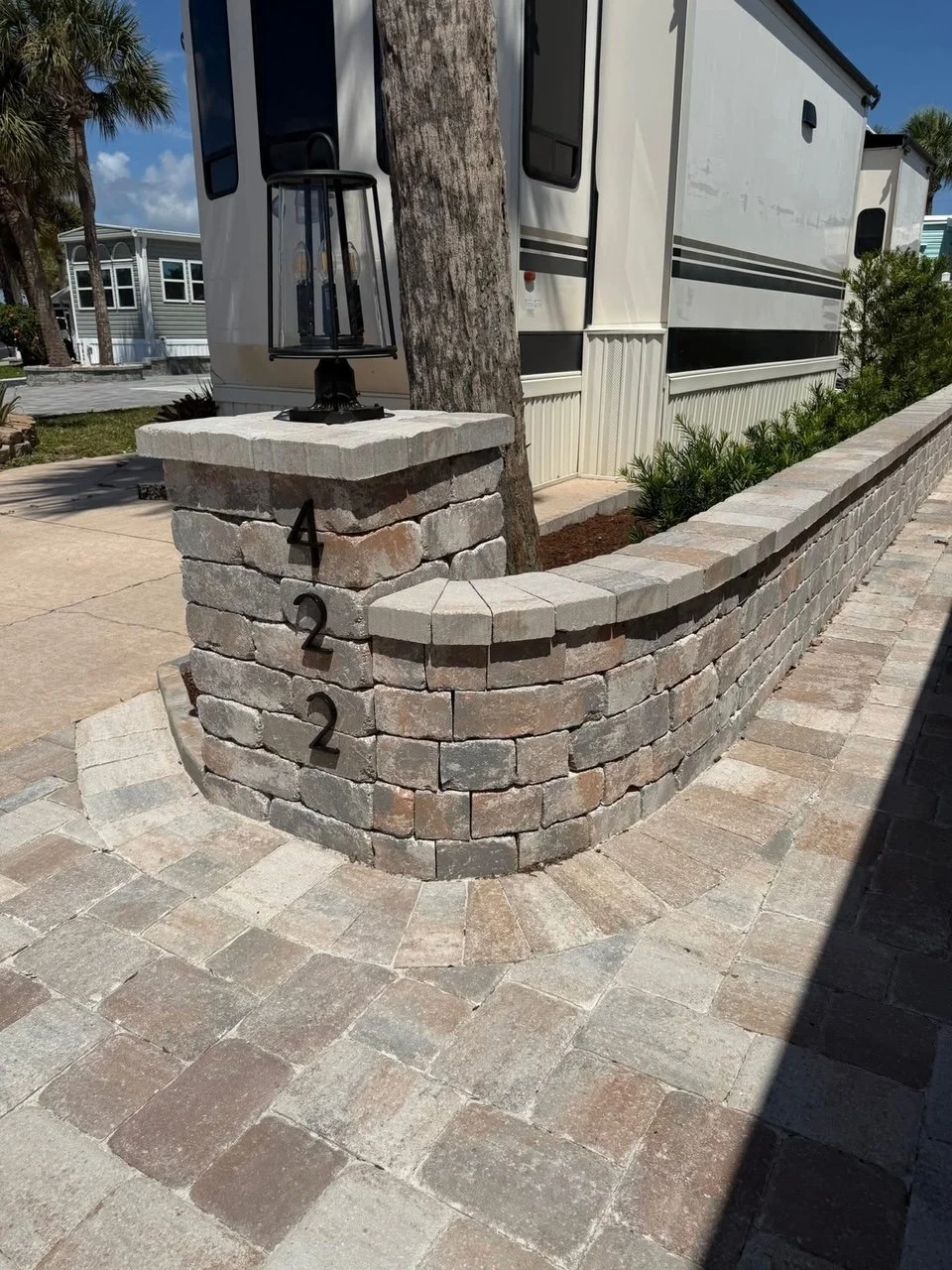 Hardscape contractor serving Brevard County with custom paver driveways, pool decks, patios, walkways, retaining walls, seating walls, outdoor kitchens, fire pits, drainage systems, concrete work, and landscape enhancements.