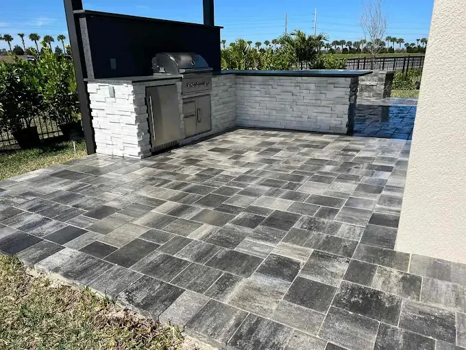 Hardscape contractor serving Brevard County with custom paver driveways, pool decks, patios, walkways, retaining walls, seating walls, outdoor kitchens, fire pits, drainage systems, concrete work, and landscape enhancements.