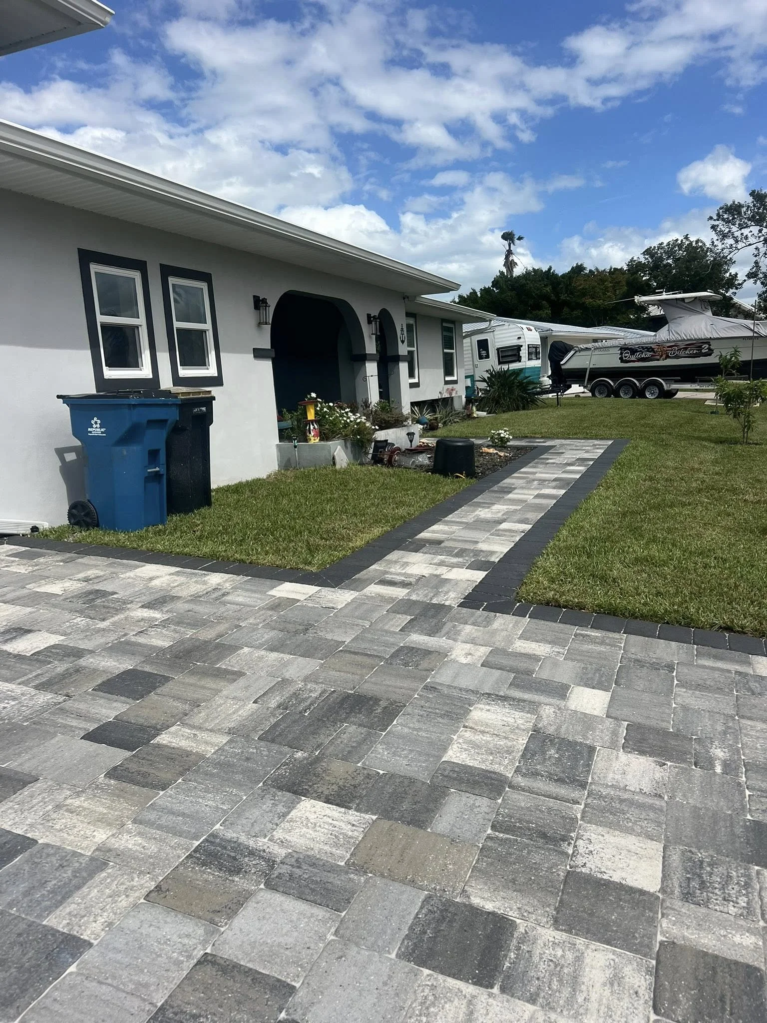 Brevard County paver contractor specializing in paver driveways, patios, pool decks, walkways, retaining walls, outdoor kitchens, fire pits, concrete driveways, concrete patios, drainage correction, decorative rock installation, artificial turf