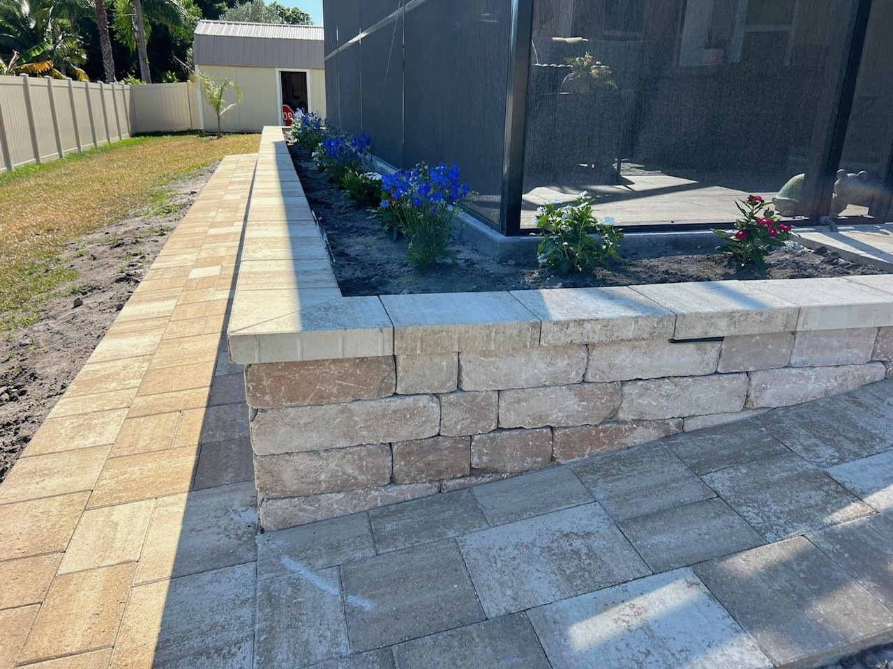 Hardscape contractor serving Brevard County with custom paver driveways, pool decks, patios, walkways, retaining walls, seating walls, outdoor kitchens, fire pits, drainage systems, concrete work, and landscape enhancements.
