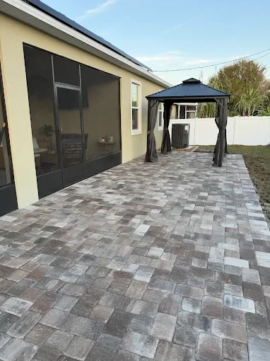 Outdoor living contractor specializing in paver patios, pool decks, outdoor kitchens, fire pits, and retaining walls serving Melbourne, Palm Bay, and surrounding Florida communities.