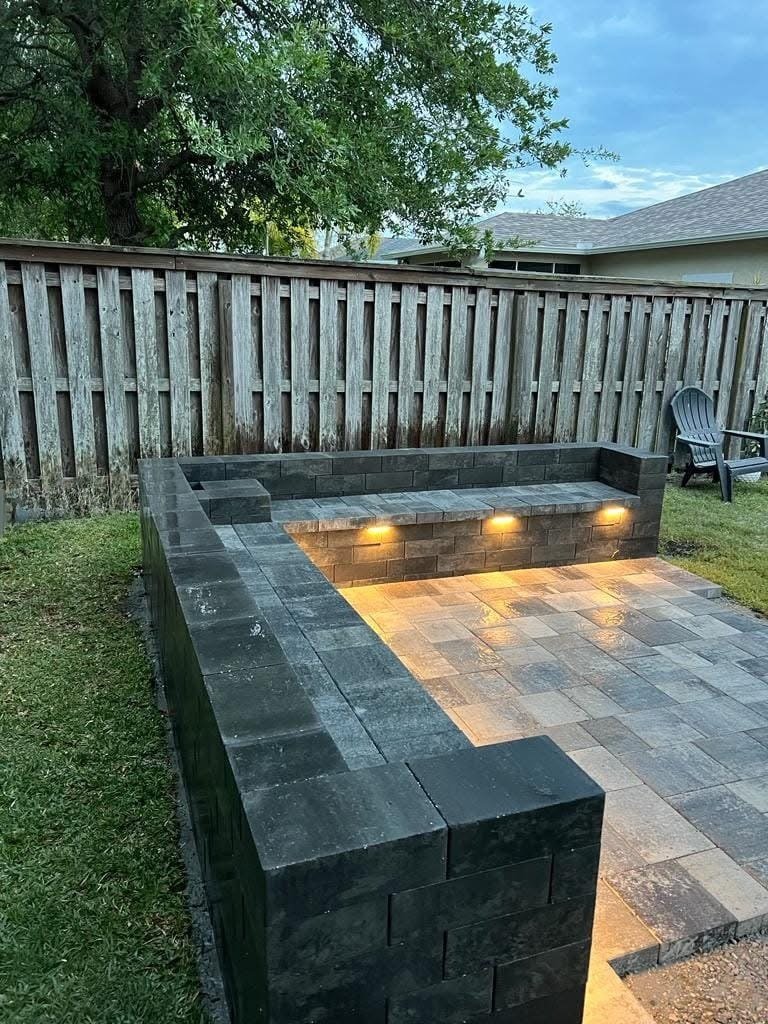 Luxury outdoor living project including a custom pool deck, paver patio, retaining wall, and outdoor entertainment space completed in Brevard County, Florida.