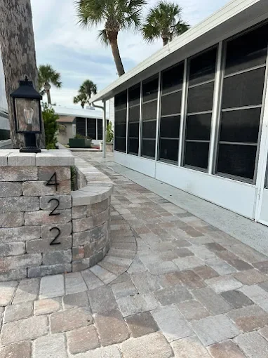 Melbourne and Palm Bay outdoor living contractor providing paver patios, pool decks, driveways, walkways, outdoor kitchens, fire pits, retaining walls, drainage solutions, concrete installation, decorative rock, and artificial turf.