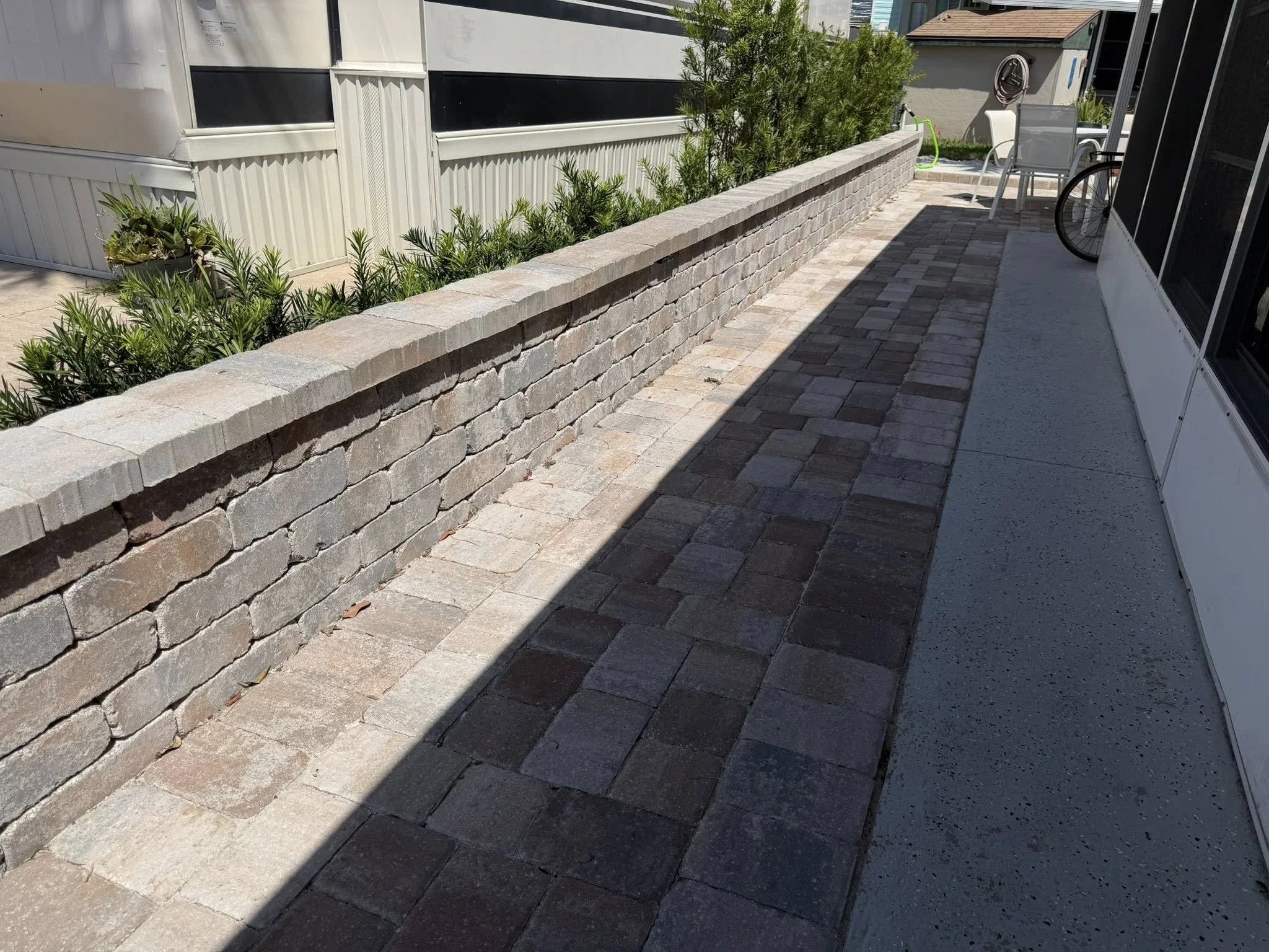 Brevard County paver contractor specializing in paver driveways, patios, pool decks, walkways, retaining walls, outdoor kitchens, fire pits, concrete driveways, concrete patios, drainage correction, decorative rock installation, artificial turf