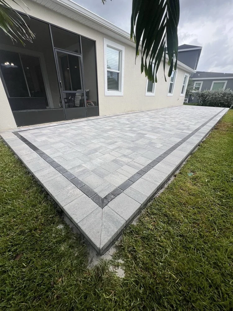 Melbourne and Palm Bay outdoor living contractor providing paver patios, pool decks, driveways, walkways, outdoor kitchens, fire pits, retaining walls, drainage solutions, concrete installation, decorative rock, and artificial turf.