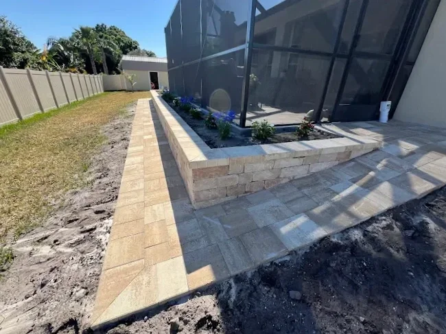 Outdoor living contractor serving Brevard County with paver driveways, patios, pool decks, retaining walls, artificial turf, concrete and drainage services.