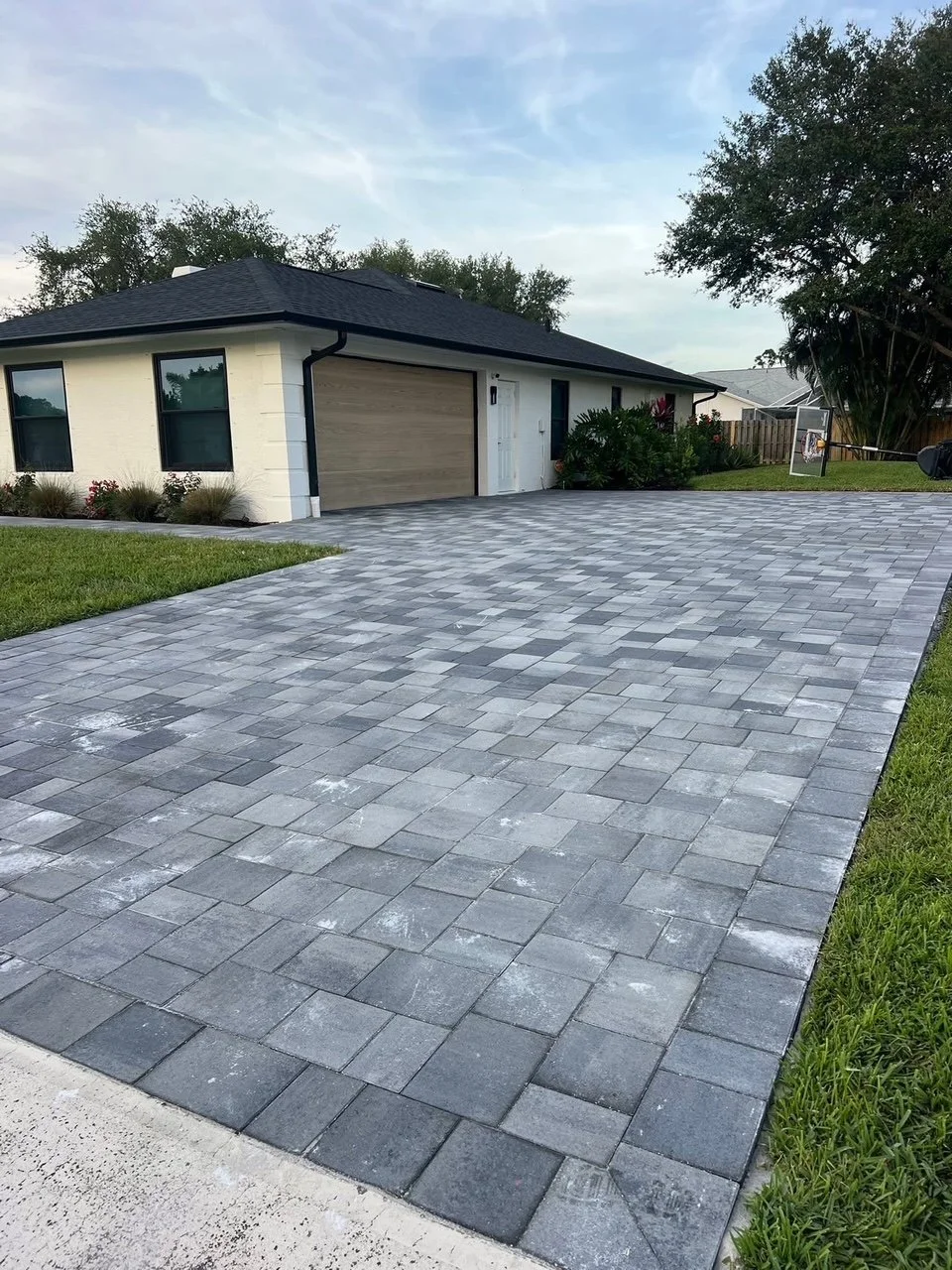 Hardscape contractor serving Brevard County with custom paver driveways, pool decks, patios, walkways, retaining walls, seating walls, outdoor kitchens, fire pits, drainage systems, concrete work, and landscape enhancements.