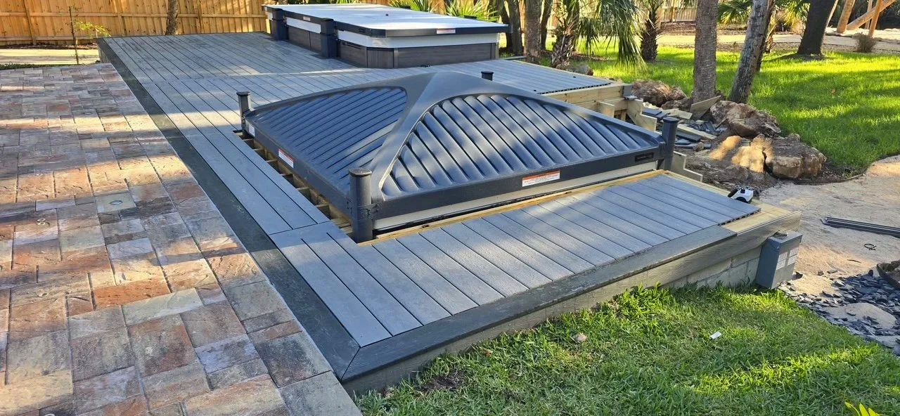 Custom outdoor living and hardscape installation featuring paver patios, pool decks, driveways, walkways, retaining walls, drainage systems, and landscape enhancements throughout Brevard County, Florida.