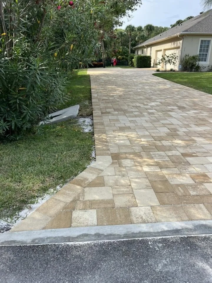 Brevard County paver contractor specializing in paver driveways, patios, pool decks, walkways, retaining walls, outdoor kitchens, fire pits, concrete driveways, concrete patios, drainage correction, decorative rock installation, artificial turf