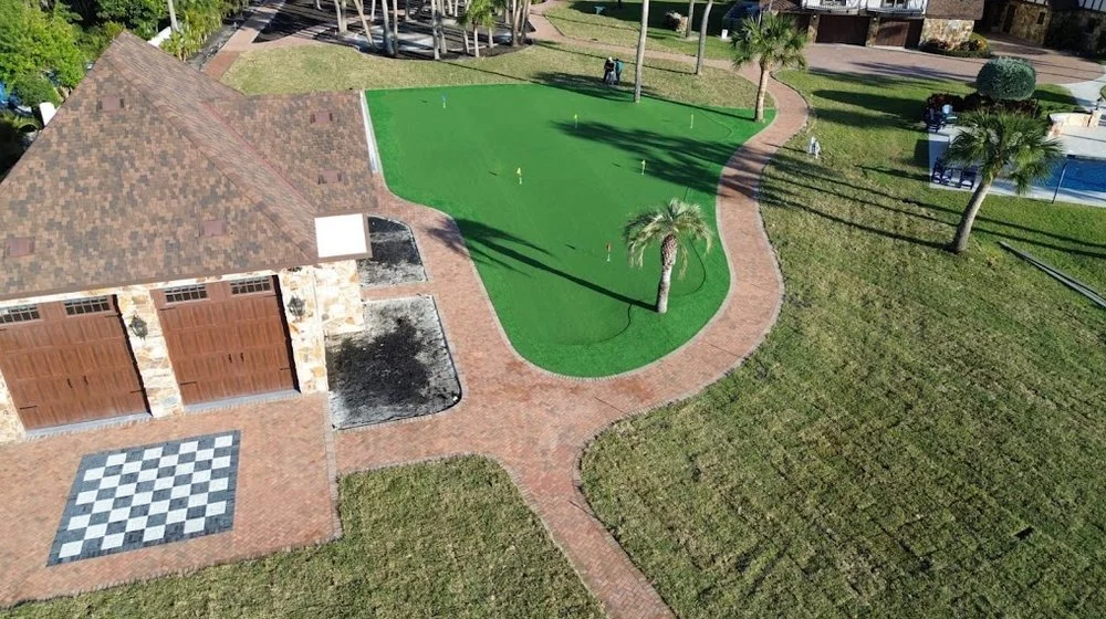 Melbourne and Palm Bay outdoor living contractor providing paver patios, pool decks, driveways, walkways, outdoor kitchens, fire pits, retaining walls, drainage solutions, concrete installation, decorative rock, and artificial turf.