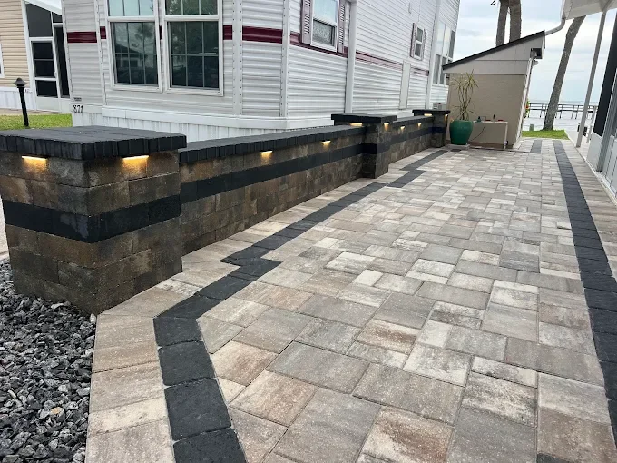 Melbourne and Palm Bay outdoor living contractor providing paver patios, pool decks, driveways, walkways, outdoor kitchens, fire pits, retaining walls, drainage solutions, concrete installation, decorative rock, and artificial turf.