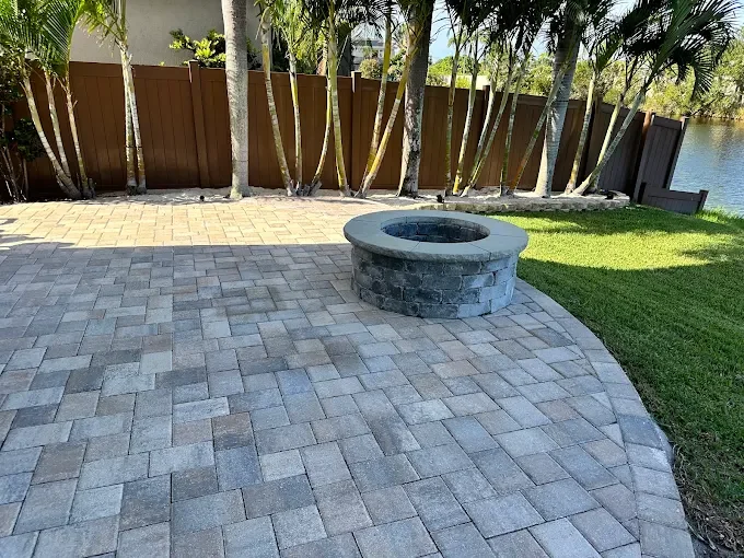 Melbourne and Palm Bay outdoor living contractor providing paver patios, pool decks, driveways, walkways, outdoor kitchens, fire pits, retaining walls, drainage solutions, concrete installation, decorative rock, and artificial turf.