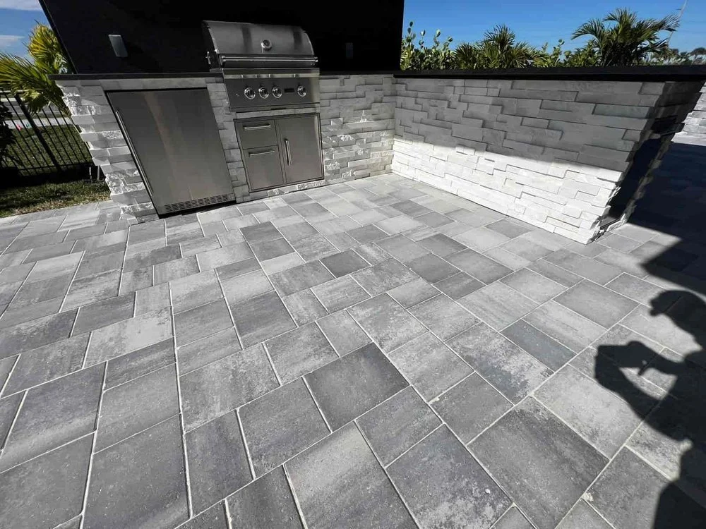 Melbourne and Palm Bay outdoor living contractor providing paver patios, pool decks, driveways, walkways, outdoor kitchens, fire pits, retaining walls, drainage solutions, concrete installation, decorative rock, and artificial turf.