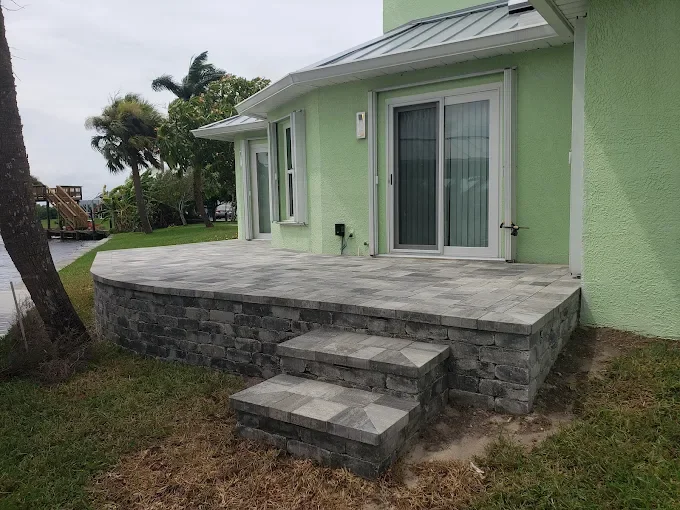 Hardscape contractor serving Brevard County with custom paver driveways, pool decks, patios, walkways, retaining walls, seating walls, outdoor kitchens, fire pits, drainage systems, concrete work, and landscape enhancements.