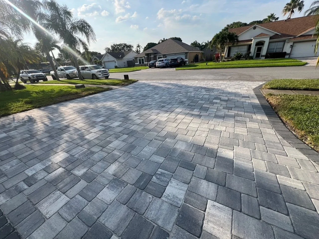 Hardscape contractor serving Brevard County with custom paver driveways, pool decks, patios, walkways, retaining walls, seating walls, outdoor kitchens, fire pits, drainage systems, concrete work, and landscape enhancements.