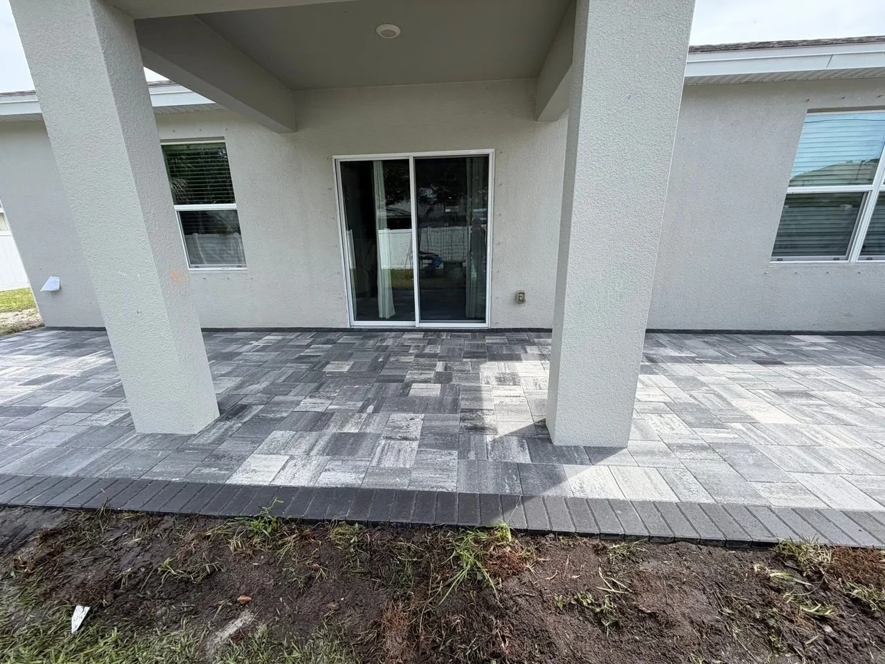 Custom outdoor renovation projects including pavers, concrete, drainage, retaining walls, and landscape improvements in Brevard County, Florida.