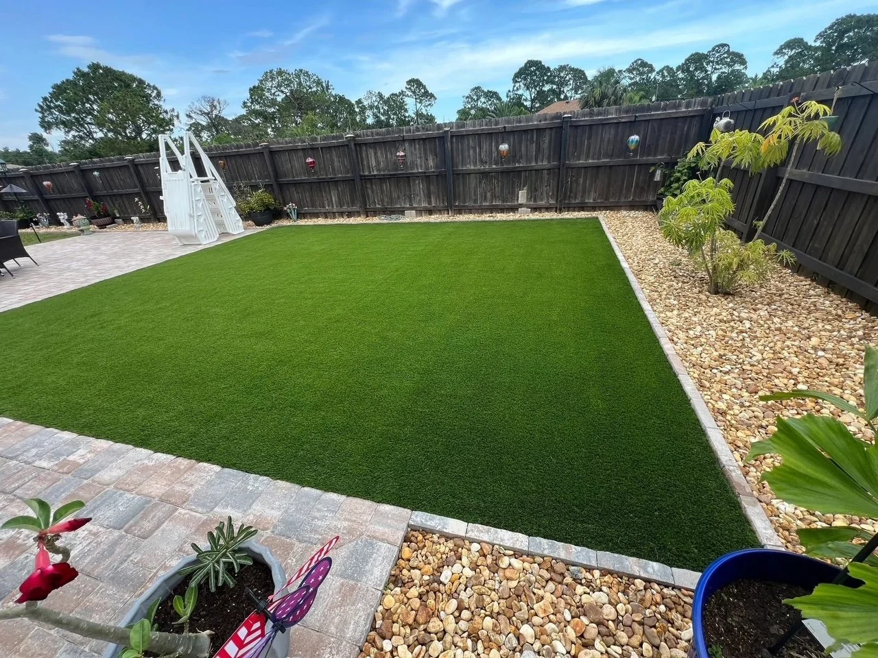 Hardscape contractor serving Brevard County with custom paver driveways, pool decks, patios, walkways, retaining walls, seating walls, outdoor kitchens, fire pits, drainage systems, concrete work, and landscape enhancements.