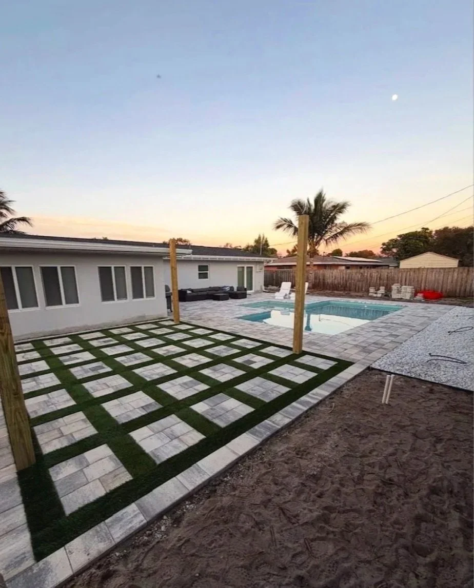 Custom residential landscape and outdoor living projects featuring decorative pavers, concrete installation, artificial turf, drainage improvements, flower beds, retaining walls, and outdoor entertainment spaces throughout Brevard County.