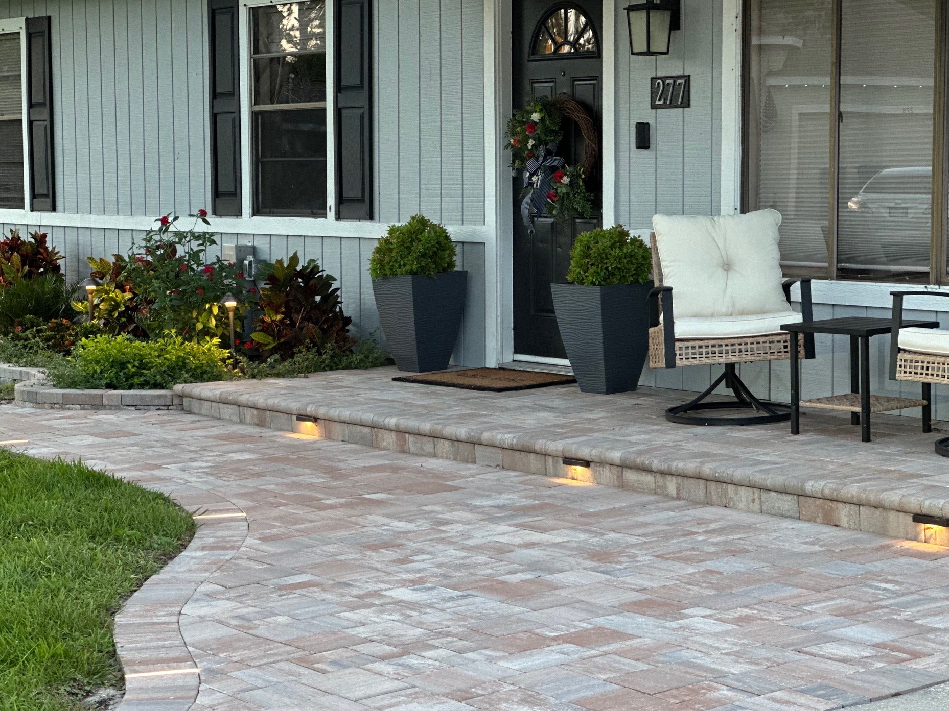 Melbourne and Palm Bay outdoor living contractor providing paver patios, pool decks, driveways, walkways, outdoor kitchens, fire pits, retaining walls, drainage solutions, concrete installation, decorative rock, and artificial turf.