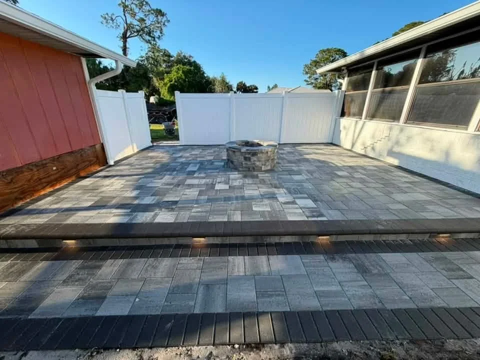 Melbourne and Palm Bay outdoor living contractor providing paver patios, pool decks, driveways, walkways, outdoor kitchens, fire pits, retaining walls, drainage solutions, concrete installation, decorative rock, and artificial turf.
