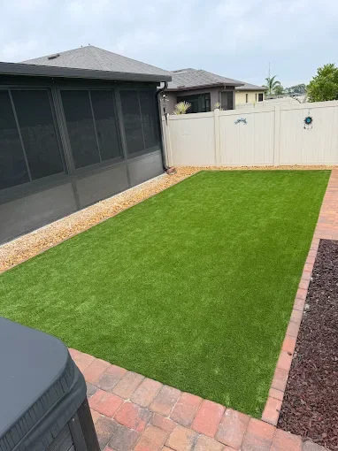 Melbourne and Palm Bay outdoor living contractor providing paver patios, pool decks, driveways, walkways, outdoor kitchens, fire pits, retaining walls, drainage solutions, concrete installation, decorative rock, and artificial turf.