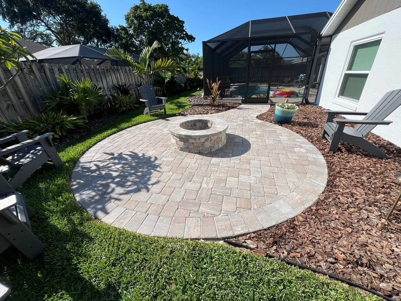 Hardscape contractor serving Brevard County with custom paver driveways, pool decks, patios, walkways, retaining walls, seating walls, outdoor kitchens, fire pits, drainage systems, concrete work, and landscape enhancements.