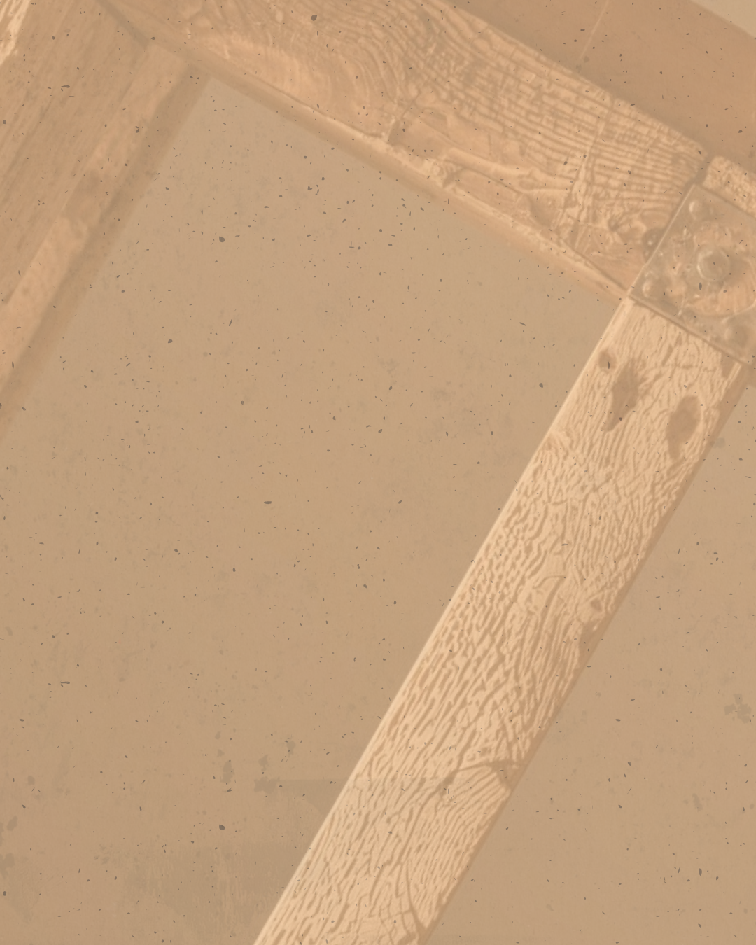 Close-up of a corner of a tile or stone surface with a textured edge and a small patch of debris or dirt.