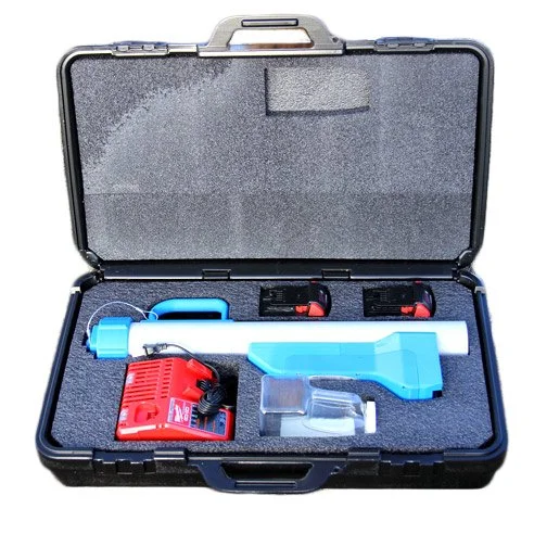 A black carrying case containing a blue and white electronic device, a red power adapter, a small transparent container, and two small black and red objects, all secured in custom foam padding.