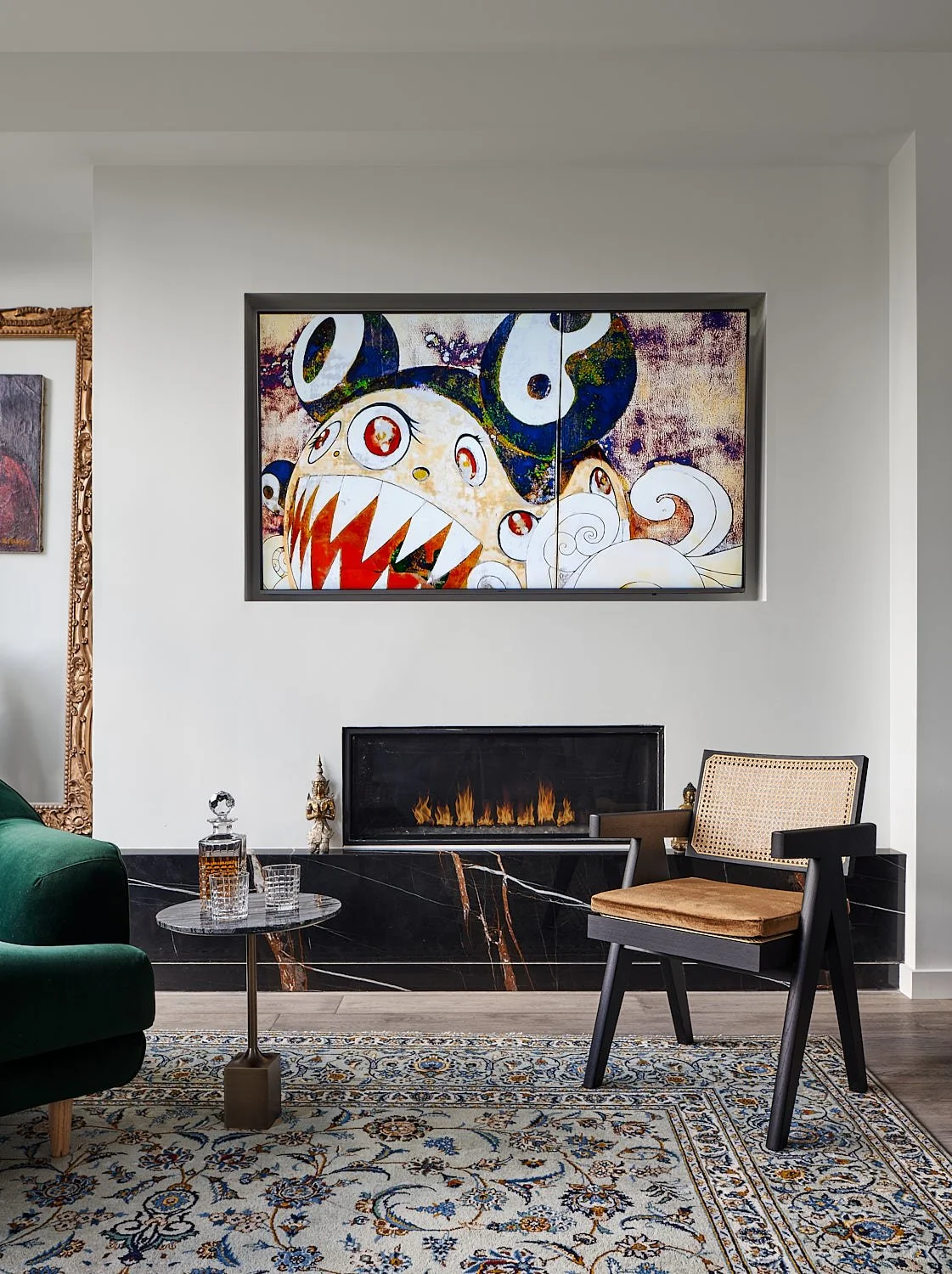Romeo’s House living room in Etobicoke, Toronto, built by Maxamin Homes, with fireplace, abstract art, green velvet chair, and marble-top side table.