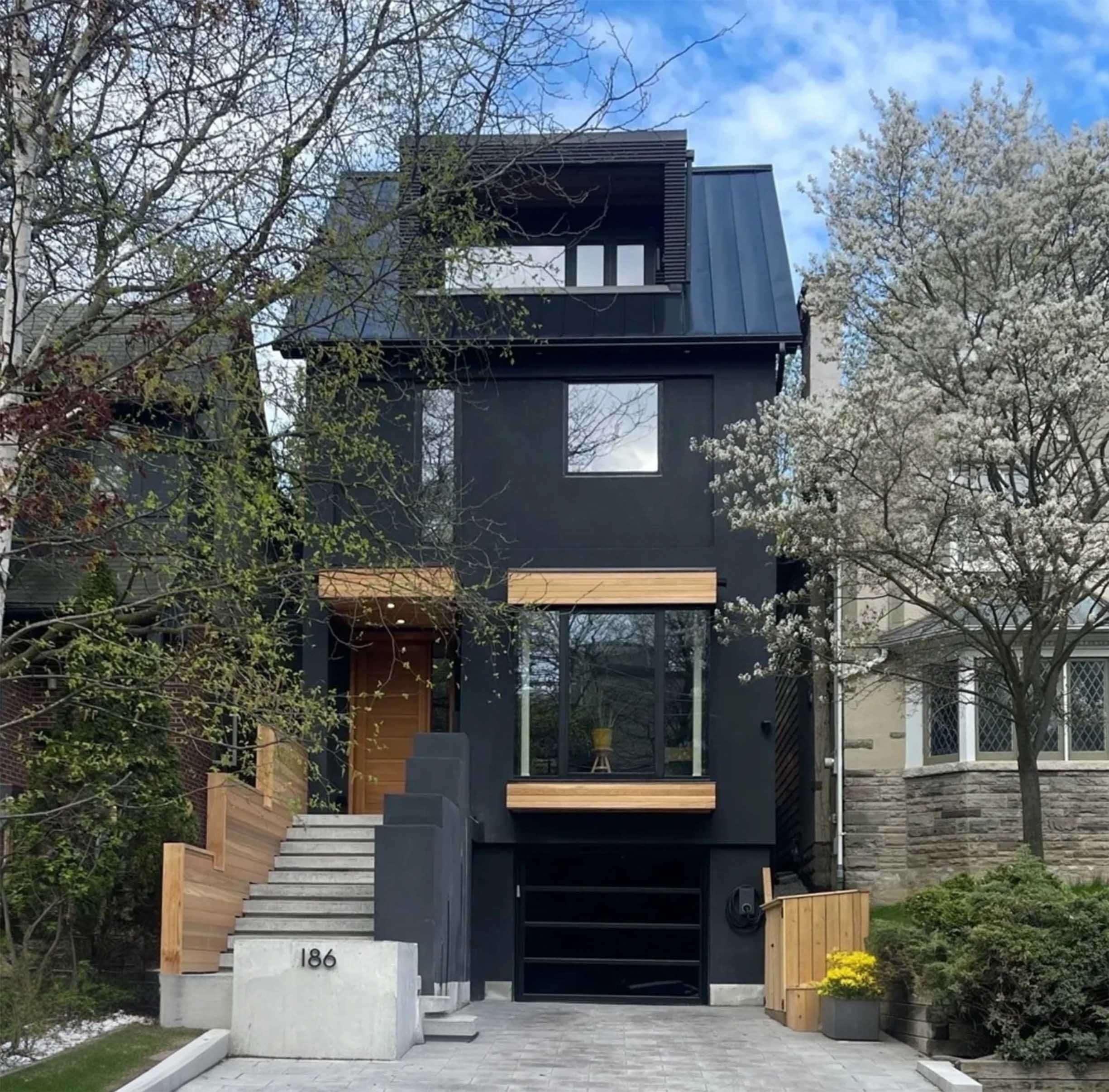Lantern House, a modern three-story luxury remodel and addition in The Beaches, Toronto, with large windows, wood accents, and Scandinavian-inspired design, built by Maxamin Homes.