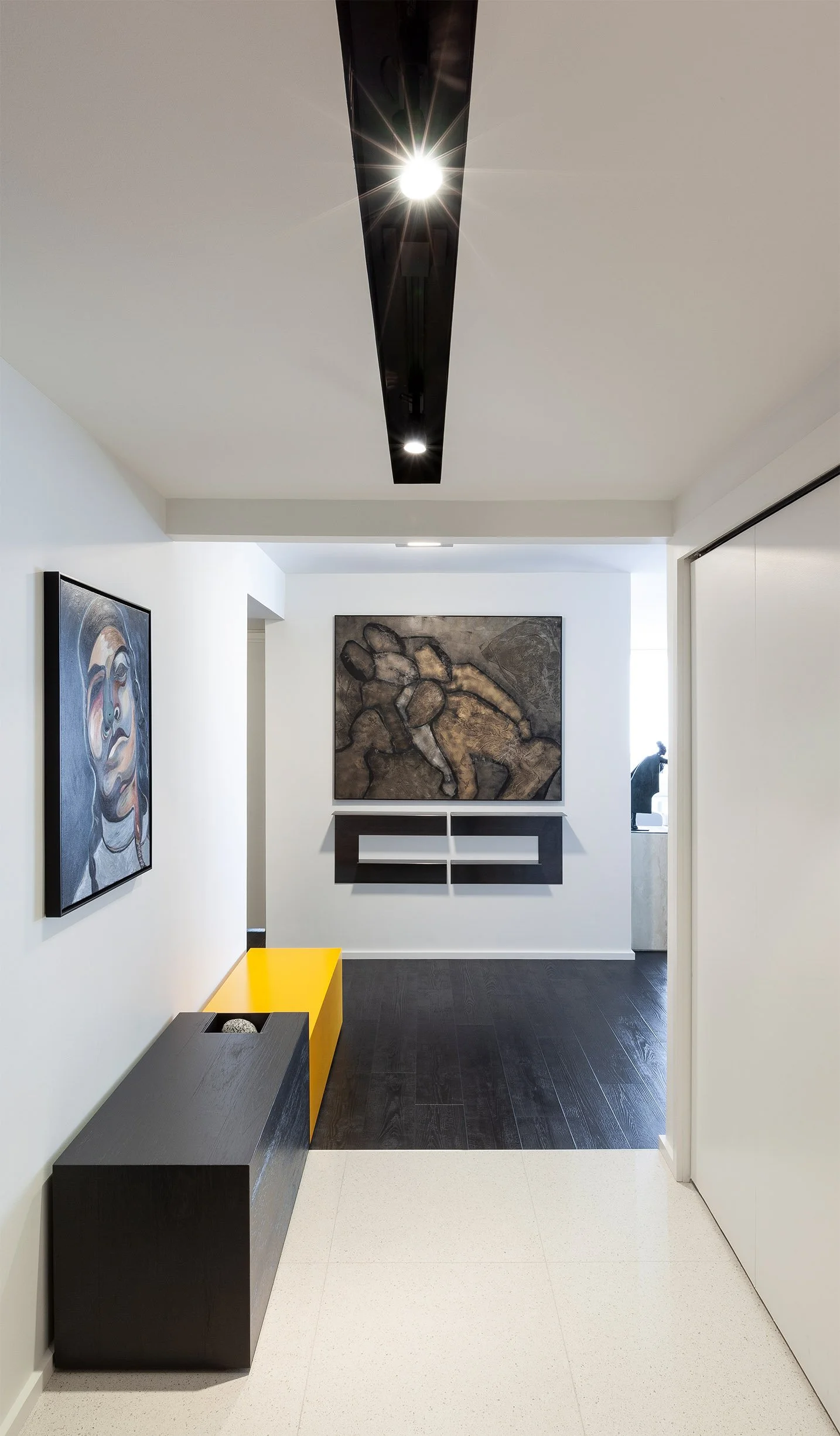 DOHA Nest, a modern home renovation in North York, Toronto, built by Maxamin Homes, featuring art gallery-style interior with white walls and black-gray paintings.