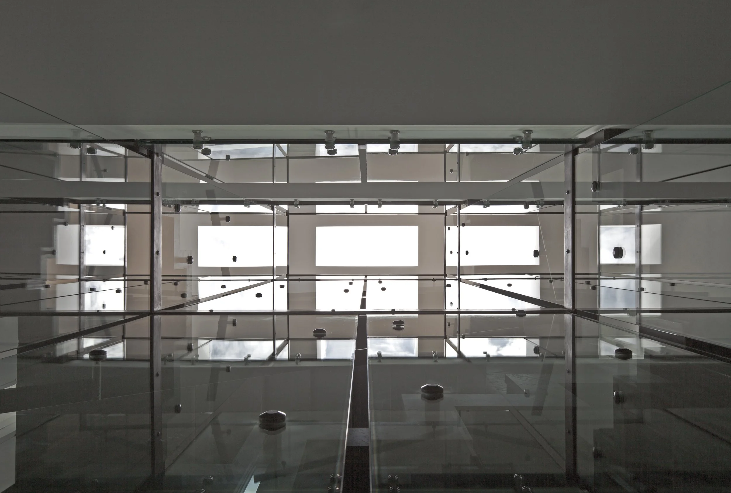 Patio House ceiling detail in North York, Toronto, built by Maxamin Homes, showing glass ceiling with metal framework and natural light through windows.
