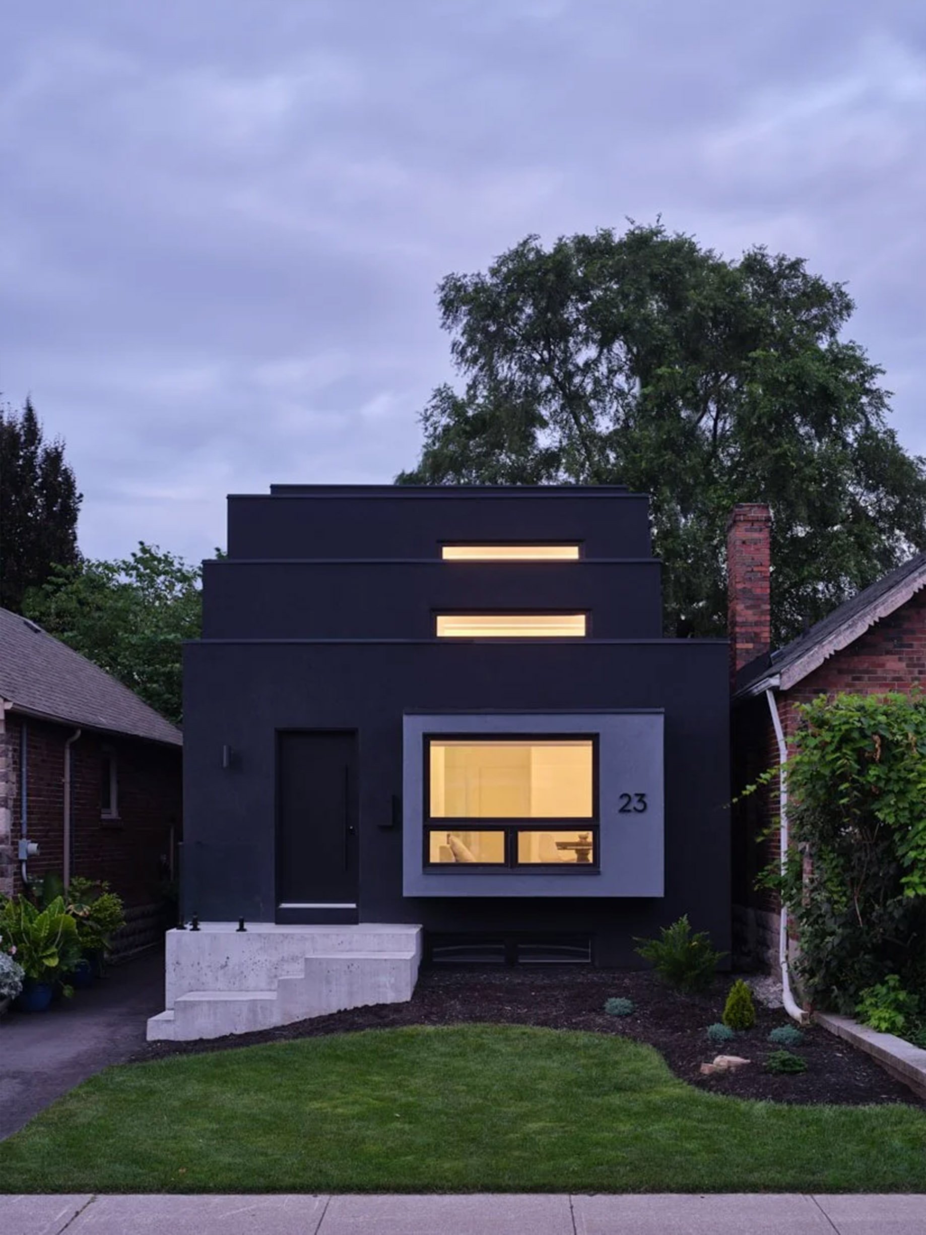 Periscope House, a luxury home addition and renovation in East York, Toronto, built by Maxamin Homes with modern black exterior, large glass windows, and minimalist design.