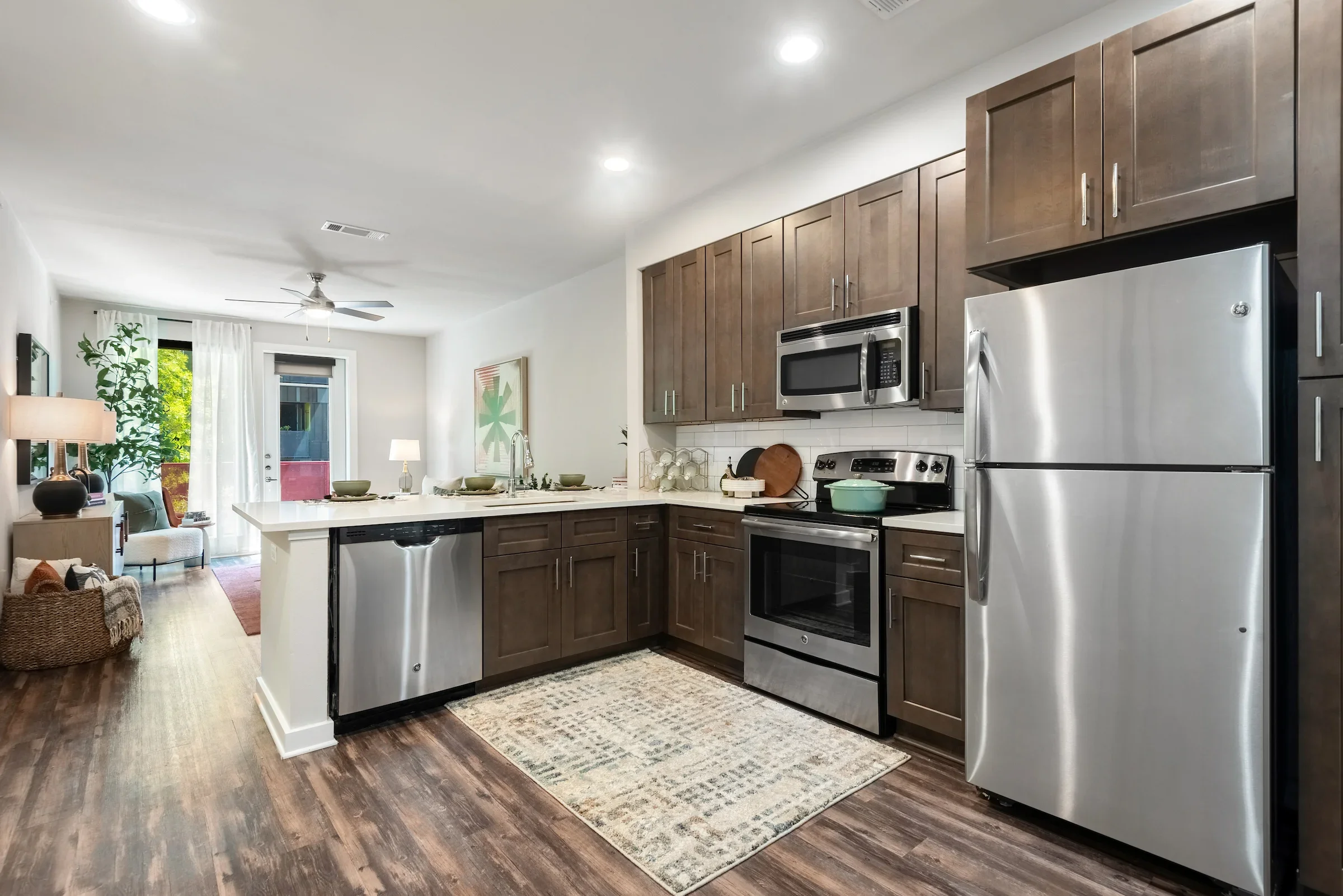 Modern Kitchen at Lamar Union With Stainless Steel Appliances and Wood-Style Flooring
