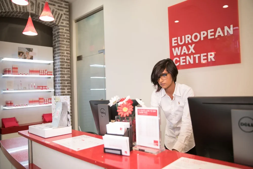 Receptionist at the front desk inside European Wax Center at Lamar Union