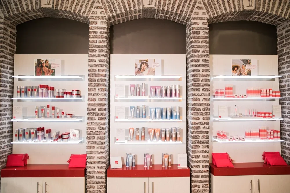 Product display shelves featuring skincare and beauty products inside European Wax Center at Lamar Union
