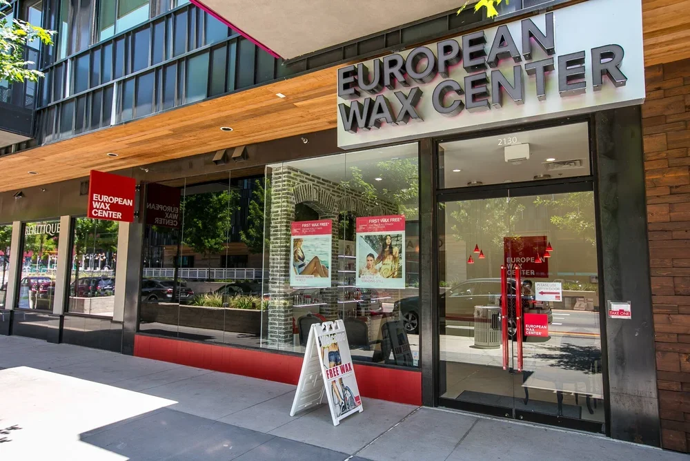 Exterior of European Wax Center at Lamar Union with large storefront sign and promotional signage