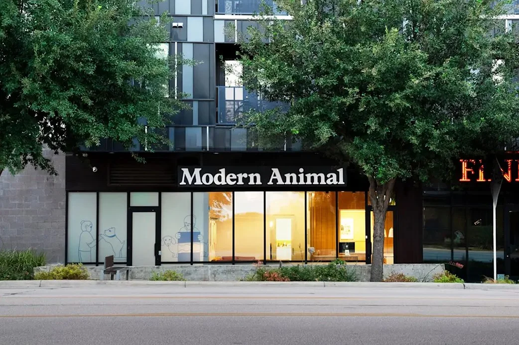 Exterior view of Modern Animal veterinary clinic with modern glass storefront and signage