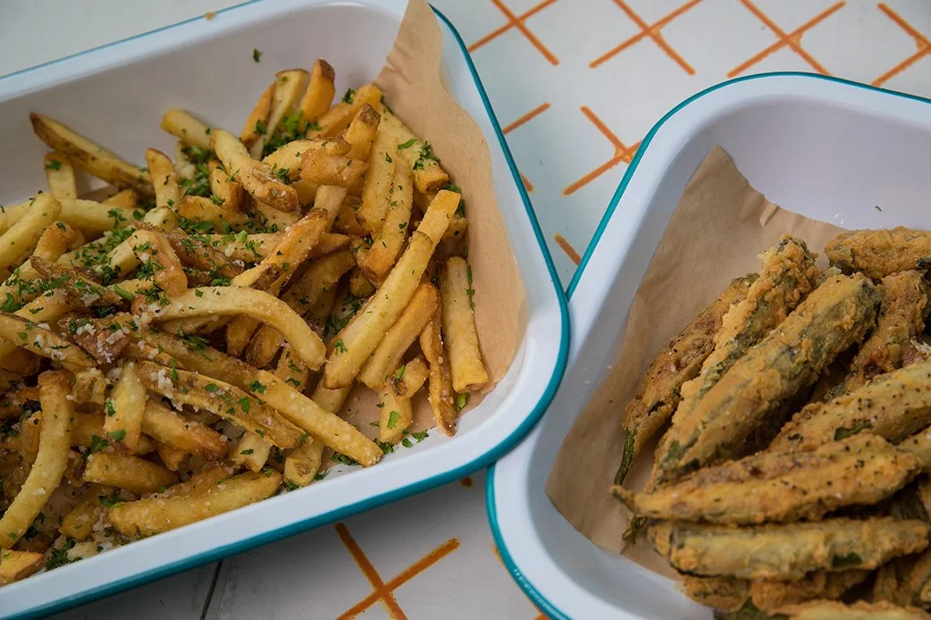 French fries and fried okra served in trays at TLC Lamar Union