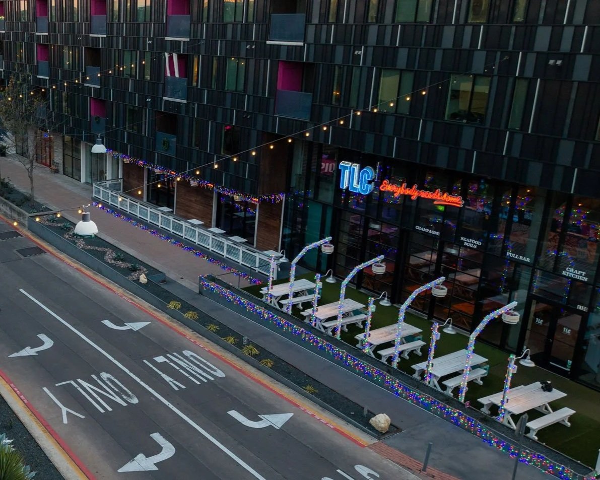 TLC at Lamar Union Storefront with Festive Outdoor Seating and String Lights
