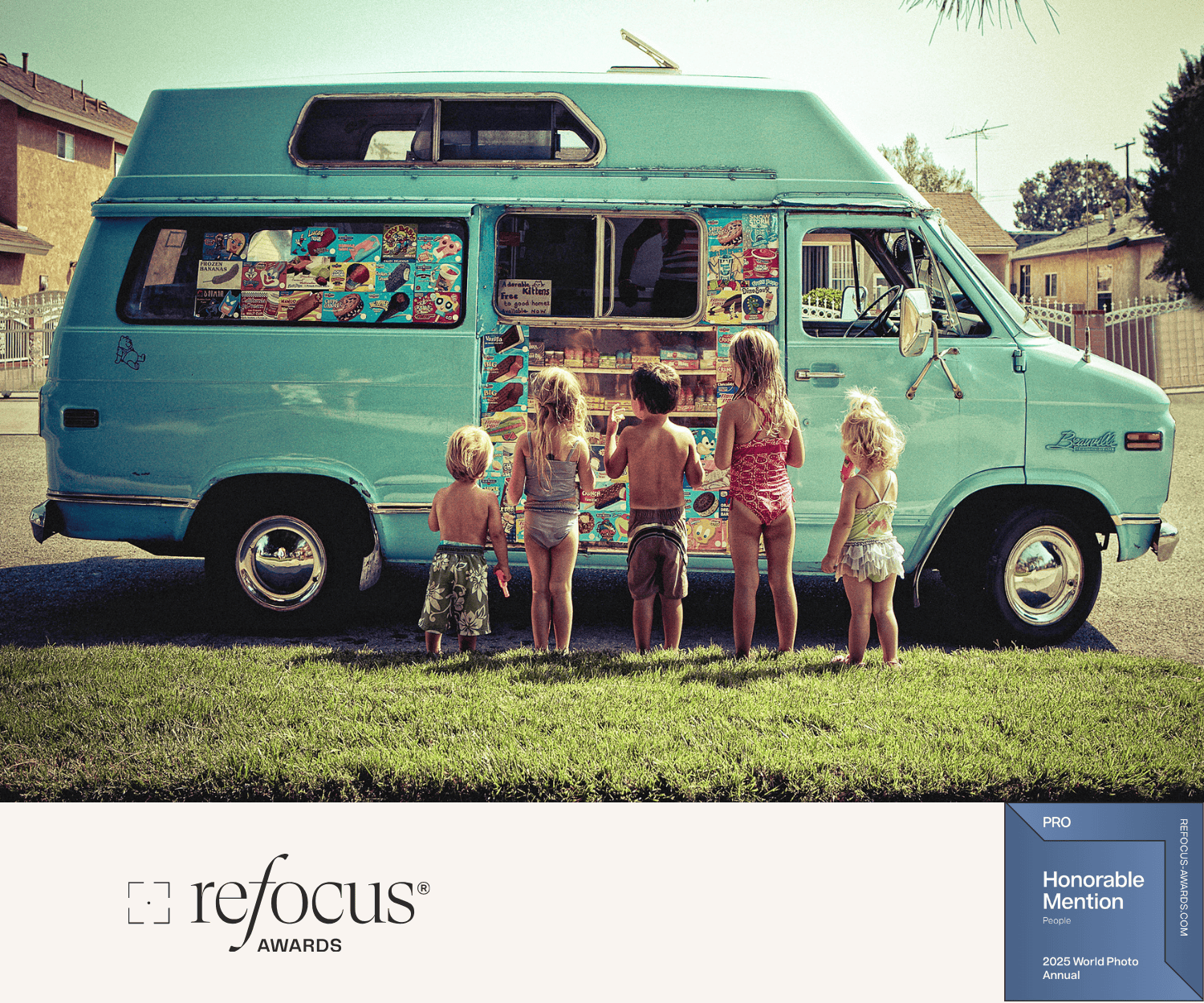 A group of six children in swimsuits standing in front of a teal ice cream and popsicle truck.