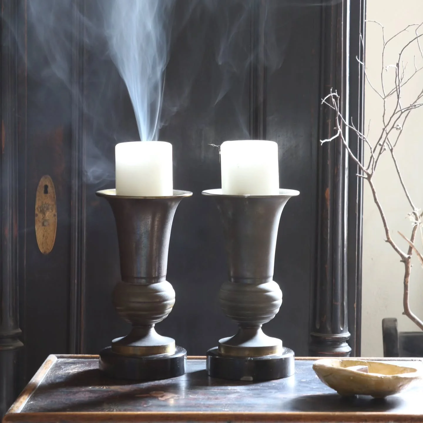 Smoke still rising.

A pair of French Art Deco metal and marble candlesticks, early to mid 20th century. Architectural in form and beautifully weighted, they bring depth and structure to an interior &mdash; whether styled on a mantelpiece, console ta