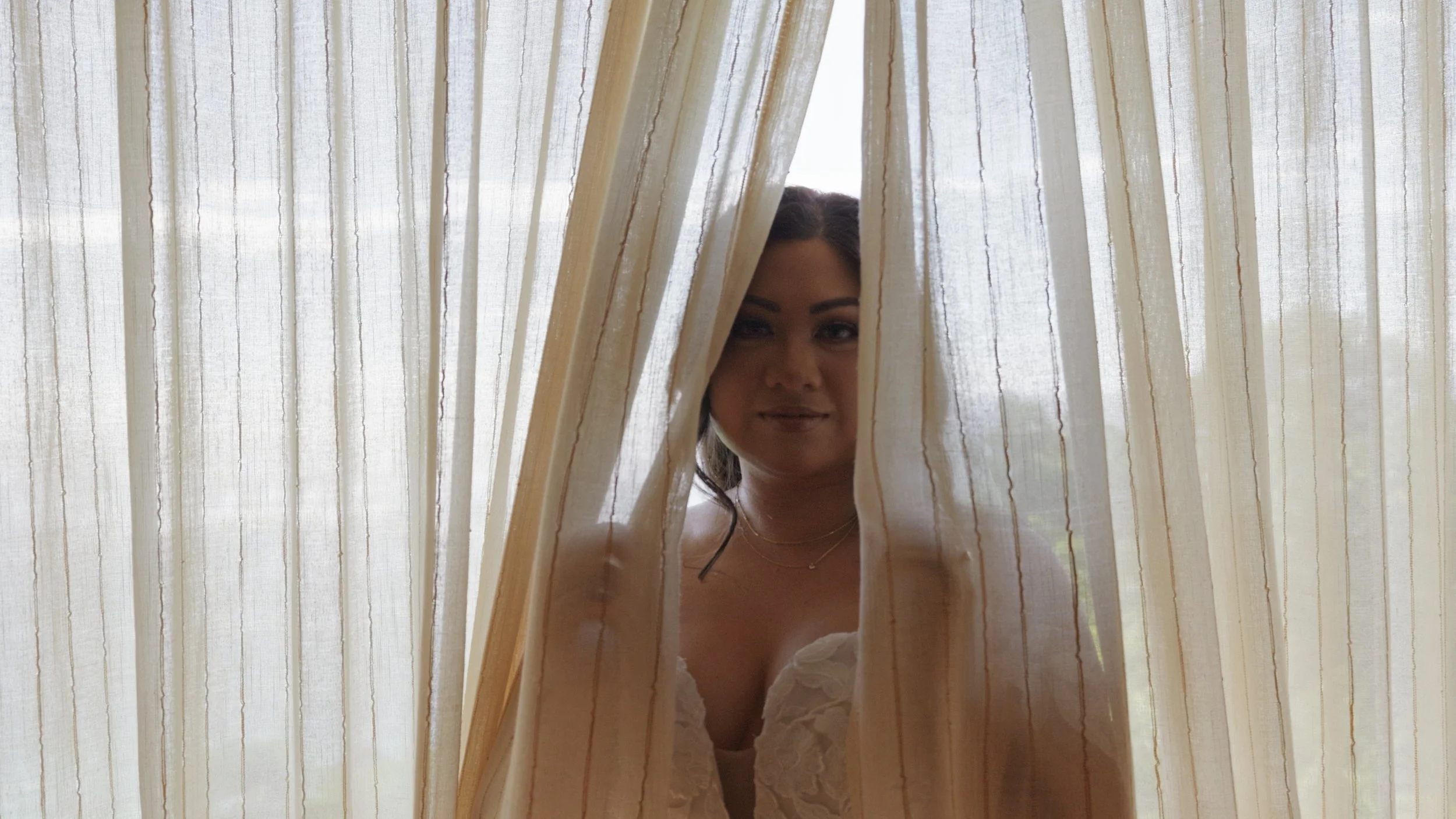 A beautiful bride peeking through a veil at Shangri La, Boracay