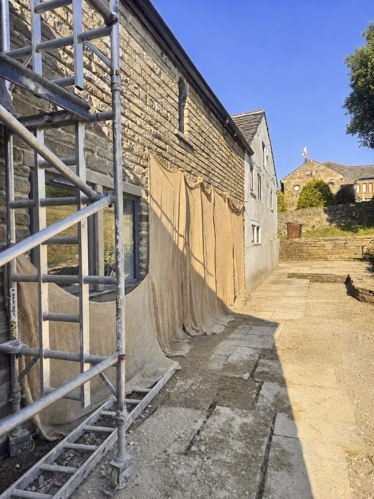 Hessian covering fresh lime pointing on the farmhouse