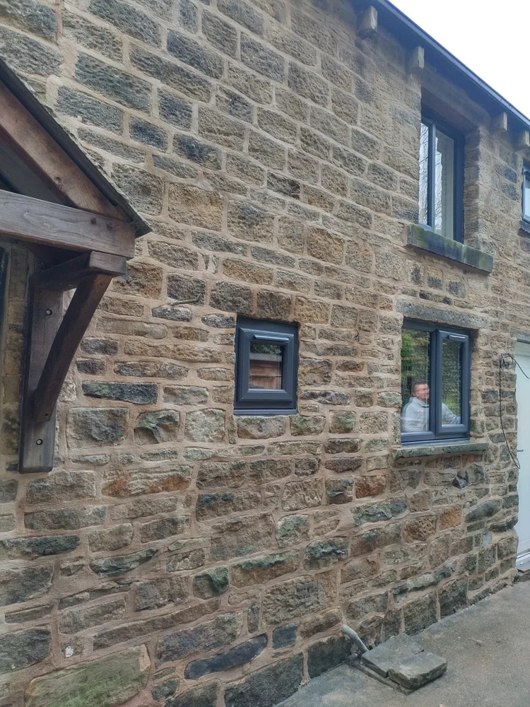 Traditional stonework with dark-framed windows