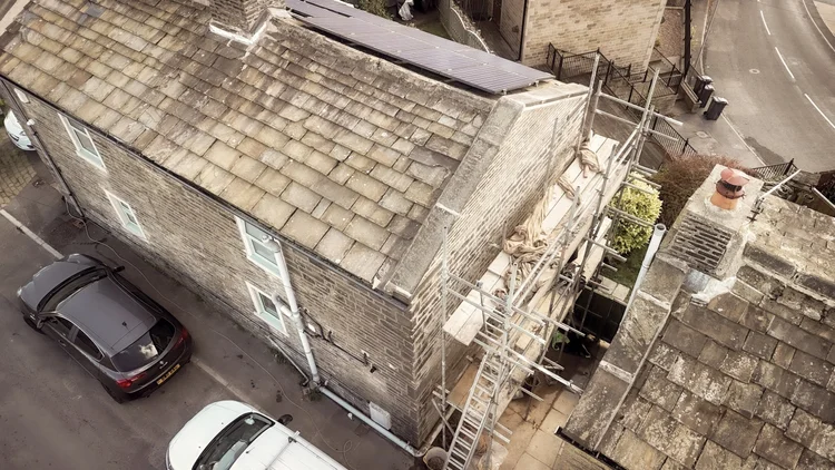 Lime repointing in progress on the gable end