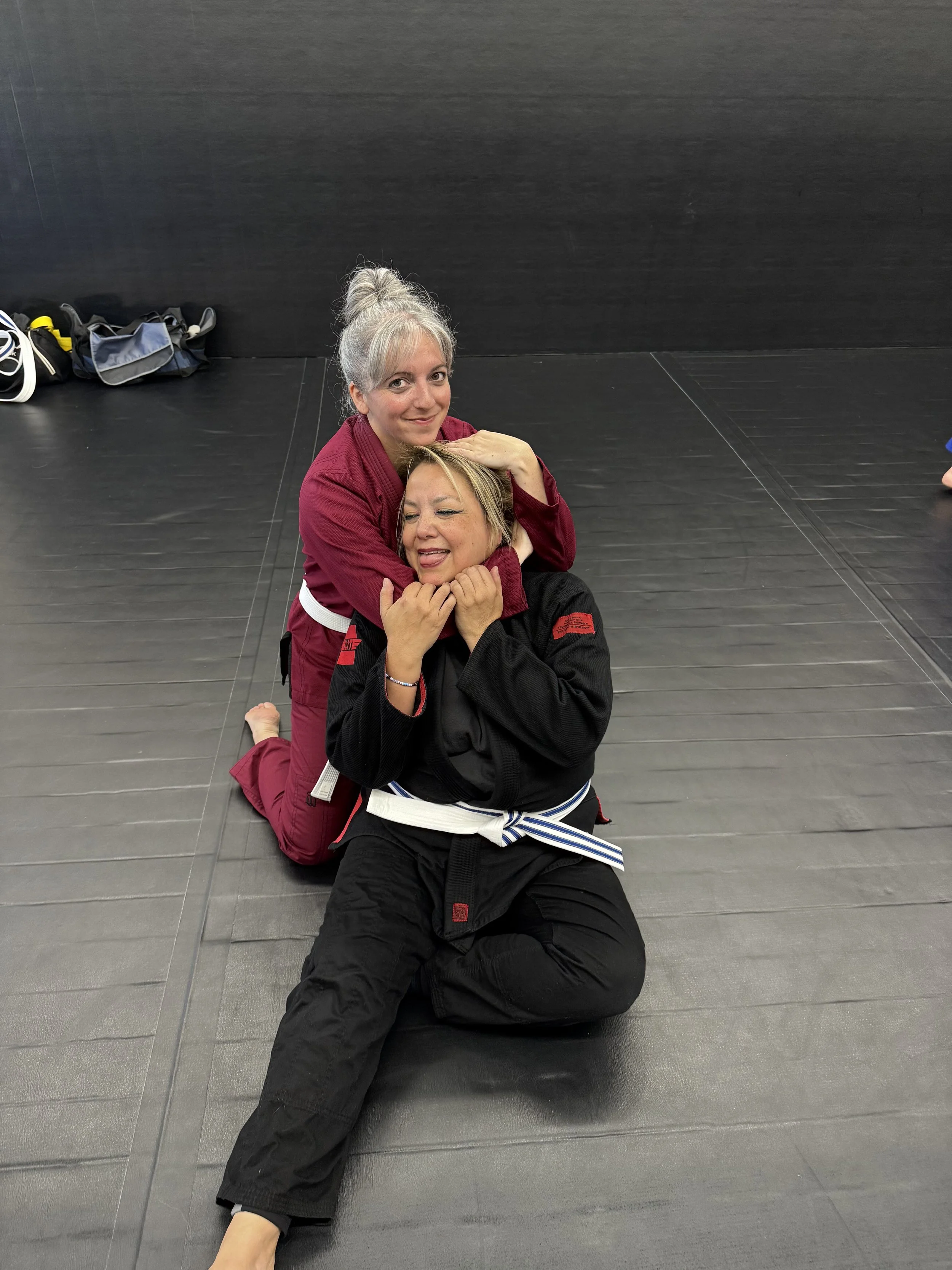 Two students practicing a Brazilian Jiu-Jitsu grappling technique.