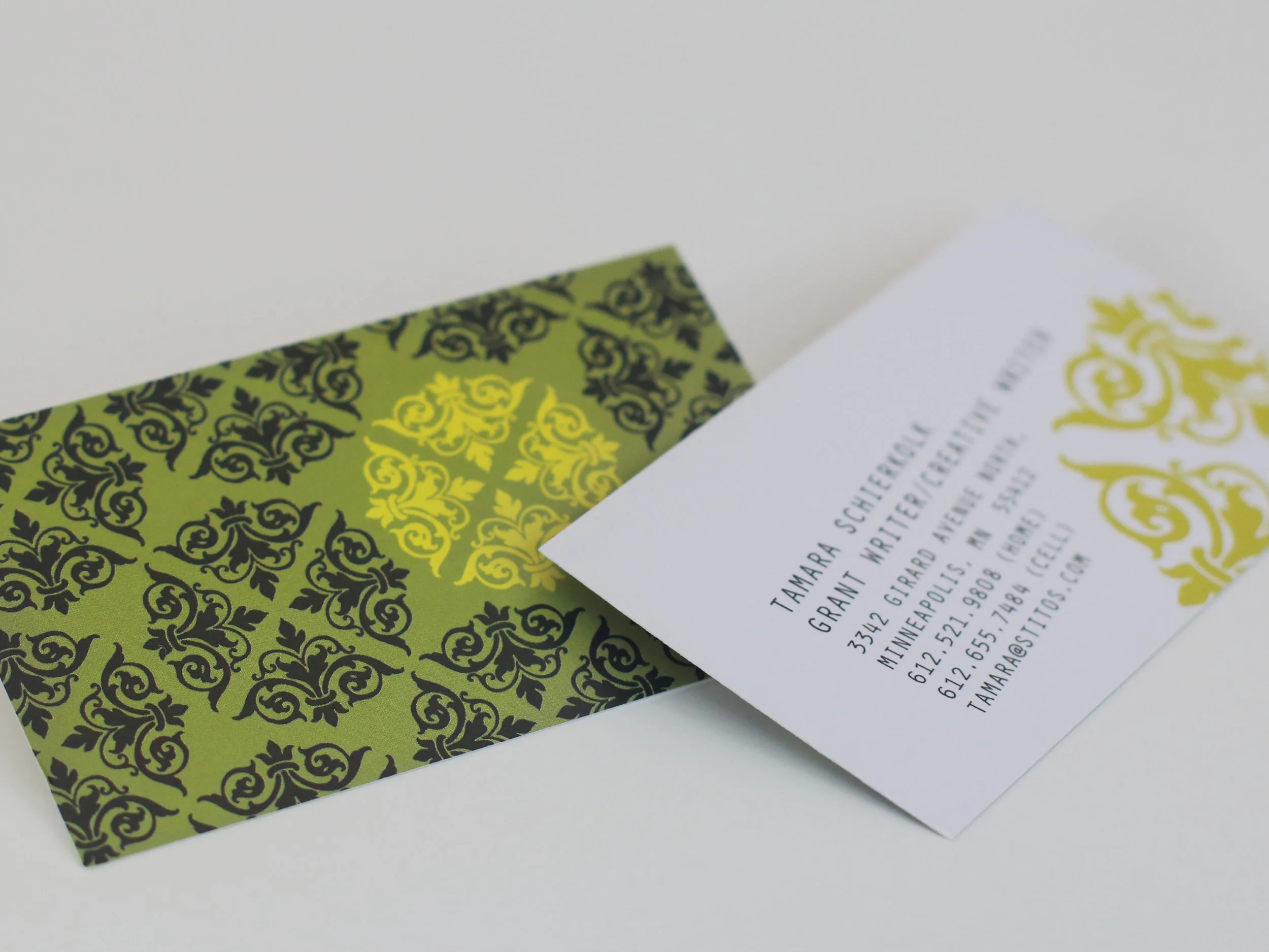 green, black, and yellow floral business card